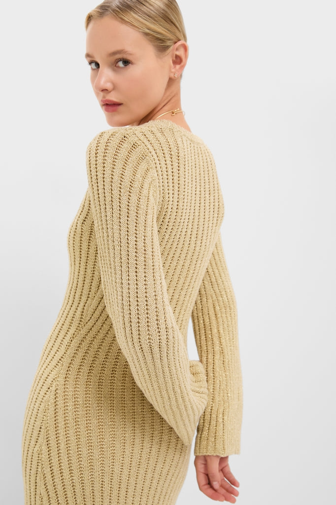 Young woman in a classic, high-end Gold Knit Amanyara Maxi Dress, effortlessly styled with long sleeves and a rib-knit texture, exuding a fun, confident vibe.