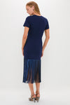 Woman in a classic Navy Sequin Fringe Stevie Midi Dress, showcasing effortless elegance with a fun, high-end flair, paired with metallic high-heel sandals.
