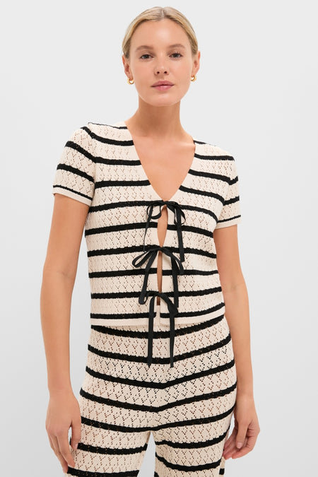 Model wearing the Black & Tan Stripe Portimao Top, featuring a classic, effortless V-neck with ribbon ties, paired with matching knit pants for a high-end, fun look.