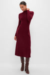 Model in an Oxblood Knit Conrad Midi Swing Dress, showcasing a classic, effortless style with ribbed texture and a mock neck, paired with high-end knee-high leather boots.