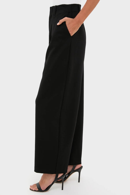 Night Out Eden Pleated Ponte Trouser showcases classic, effortless style with high-waisted, wide-leg design and stiletto pairing, embodying Tuckernuck's fun, high-end fashion ethos.