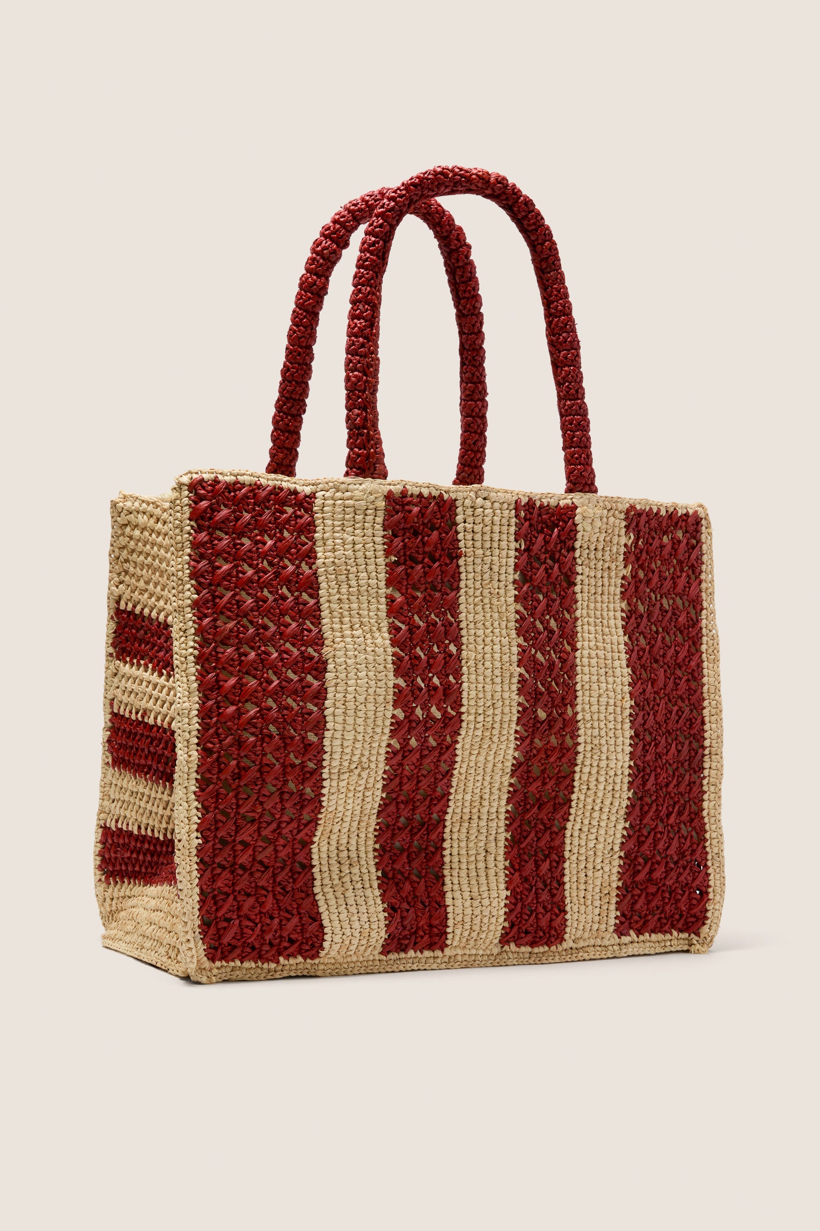 Natural and Rust Serena Large Striped Tote, handwoven from raffia with a classic winged silhouette and braided handles, offers an effortless, high-end style for fun, versatile use.