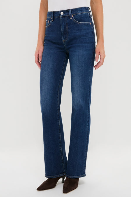 Penthouse Evie High Rise Slim Boot jeans in dark indigo, featuring a classic five-pocket style and subtle bootcut, styled effortlessly with ankle boots and a white top.