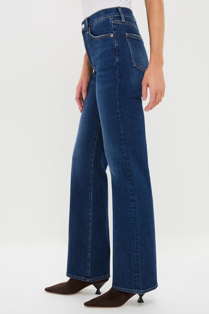 Penthouse Evie High Rise Slim Boot jeans with a wide-leg silhouette, paired with dark brown, pointed-toe ankle boots. Classic and effortlessly stylish for a high-end look.