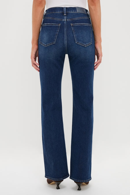 Penthouse Evie High Rise Slim Boot jeans in dark wash, showcasing a classic, effortless fit with subtle bootcut, worn with pointed-toe heels for a high-end, fun style.