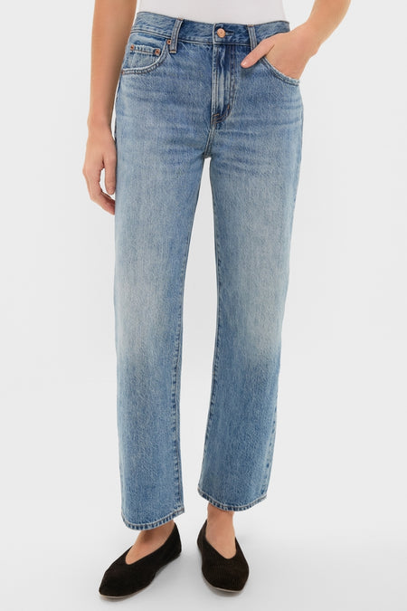 Metropolis Lexi Mid Rise Bowed Straight jeans feature classic five-pocket design, subtle fading, and clean hem, offering an effortless, high-end look modeled with fun black slip-on flats.