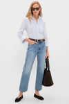 Woman in Metropolis Lexi Mid Rise Bowed Straight jeans with classic button-down, effortless flats, and fun tote, exuding high-end style and confidence.