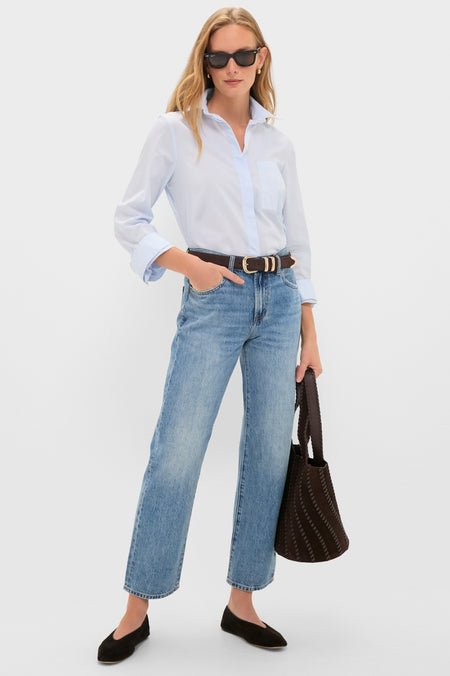 Woman in Metropolis Lexi Mid Rise Bowed Straight jeans with classic button-down, effortless flats, and fun tote, exuding high-end style and confidence.