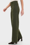 Model showcases the Laurel Penny High Rise Wide Leg pants, effortlessly paired with classic, high-end suede ankle boots, embodying Tuckernuck's fun and confident style.