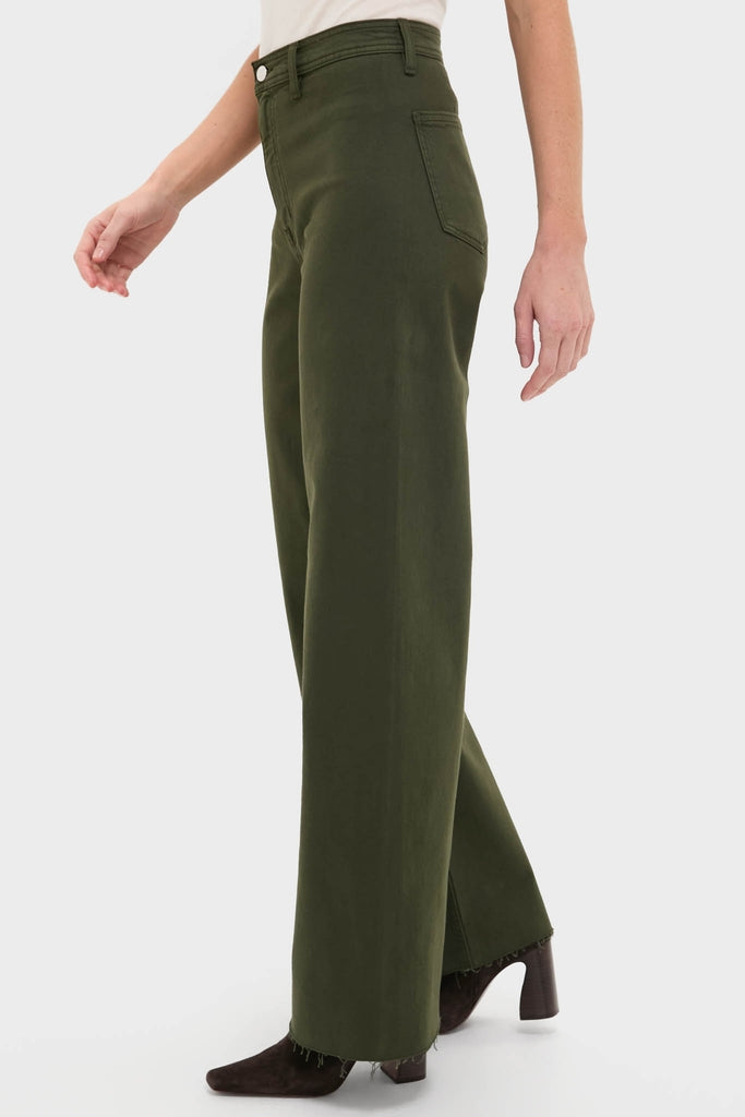 Model showcases the Laurel Penny High Rise Wide Leg pants, effortlessly paired with classic, high-end suede ankle boots, embodying Tuckernuck's fun and confident style.