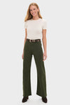 Woman wearing Laurel Penny High Rise Wide Leg trousers with a classic, effortless style; paired with a tucked cream top and dark brown heeled ankle boots.