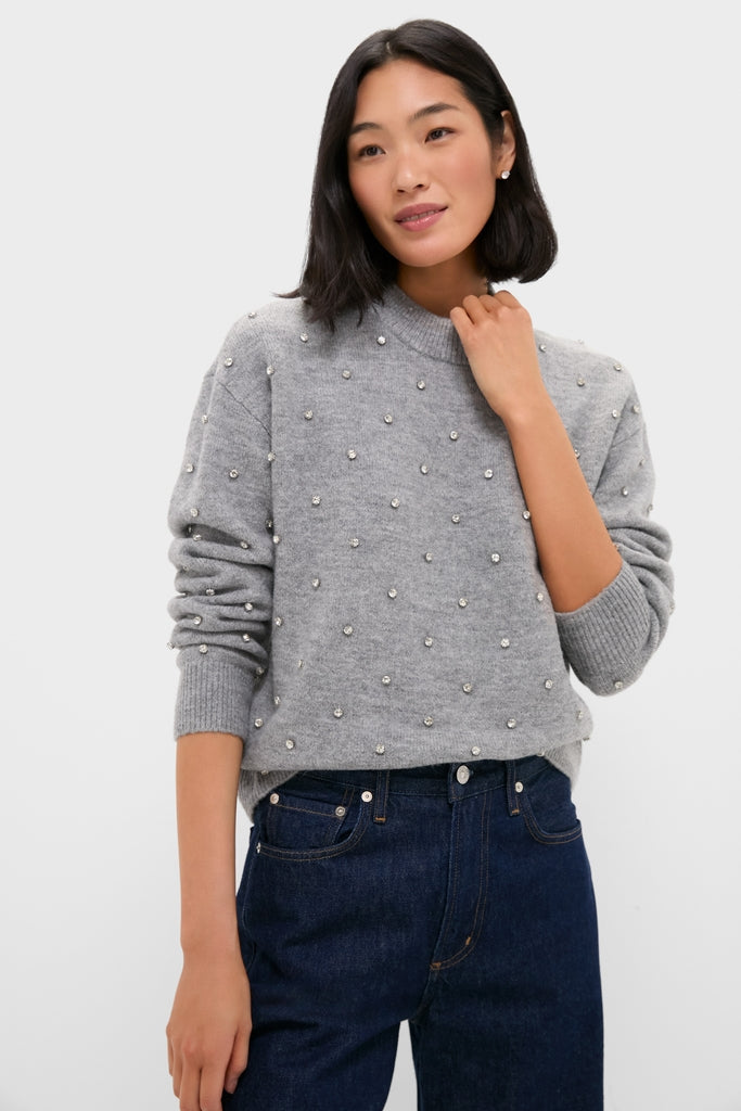 Model wearing Charcoal Diamonte Aura Sweater with crystal embellishments, paired with dark-blue jeans, showcasing a classic, effortless, and fun style for a high-end, everyday look.