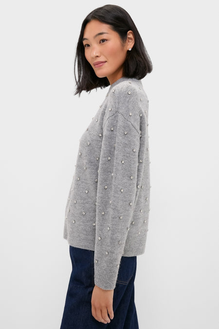 Young woman in profile wearing the Charcoal Diamonte Aura Sweater, featuring a relaxed fit, classic crew neckline, and crystal embellishments, embodying effortless, fun, high-end style.