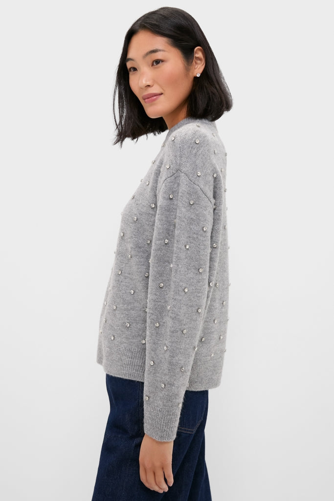 Young woman in profile wearing the Charcoal Diamonte Aura Sweater, featuring a relaxed fit, classic crew neckline, and crystal embellishments, embodying effortless, fun, high-end style.