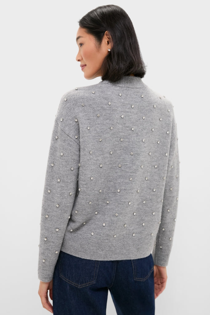 Person wearing Charcoal Diamonte Aura Sweater, featuring a classic, relaxed fit with crystal embellishments and ribbed finishes, paired effortlessly with dark blue denim jeans.