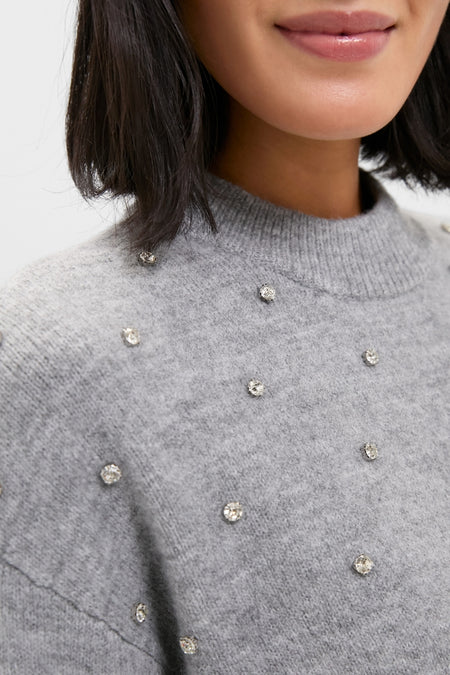 Woman in a Charcoal Diamonte Aura Sweater with crystal embellishments, showcasing a classic and effortless style with a high-end, fun touch.
