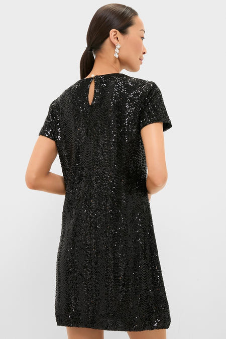 Woman modeling the Black Sequin Roya Swing Mini Dress, featuring short sleeves and shimmering sequins, embodying a classic and effortless high-end style.