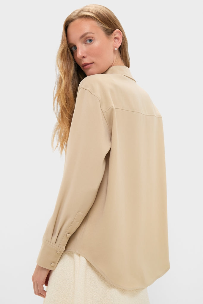 Model in beige Gold Noelle Button Down, showcasing its classic, relaxed fit and gold shine, embodying Tuckernuck's effortless, fun, high-end fashion ethos.