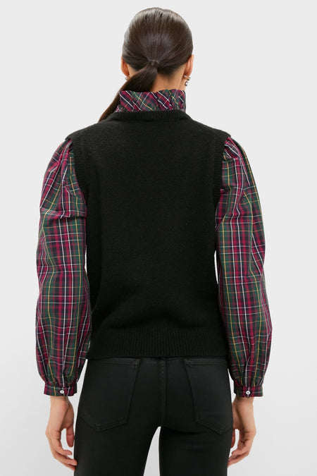 Back view of a woman in the Tartan Ella Sweater Blouse, featuring a classic sleeveless knit vest over a plaid shirt, embodying effortless, high-end style for festive occasions.