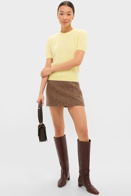 Classic and effortless, the Lemongrass Brushed Merino Wool Puff Sleeve Lexie Sweater adds a chic touch with its puff sleeves and diamond knit texture, styled elegantly with a tweed skirt.