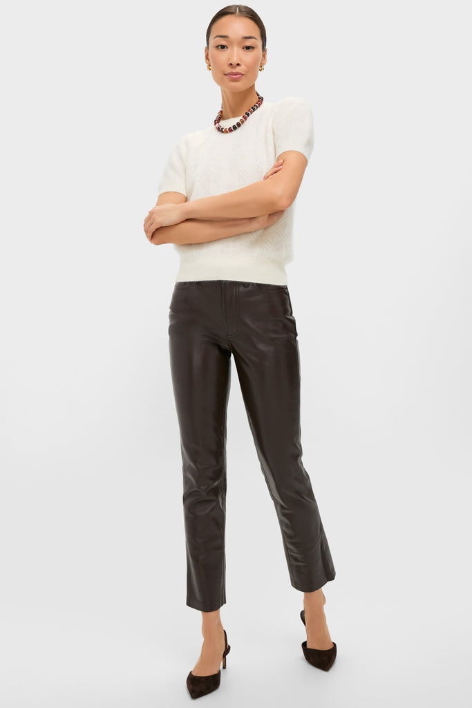 Model wears the classic Ivory Brushed Merino Wool Puff Sleeve Lexie Sweater, styled effortlessly with chic leather pants and accessories, embodying a high-end, fun sophistication.