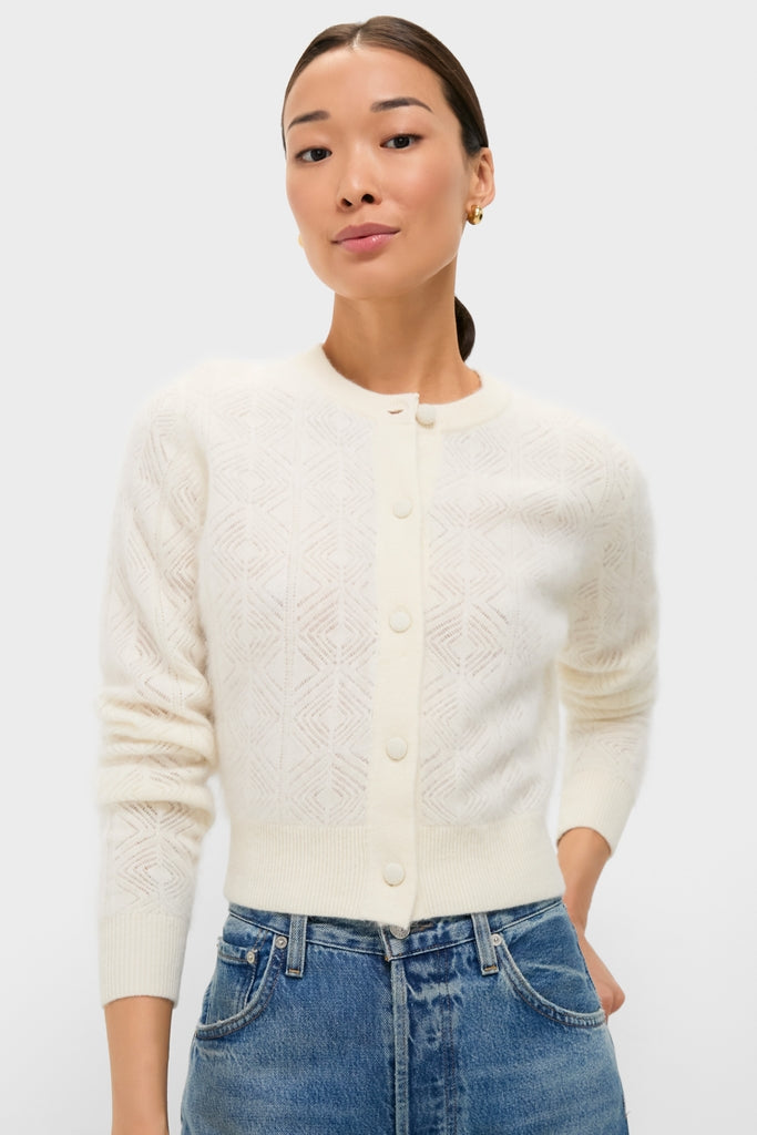 Ivory Brushed Merino Wool Macy Cardigan, classic and high-end, with geometric eyelet pattern and matching buttons, tucked into jeans for an effortless, fun look.