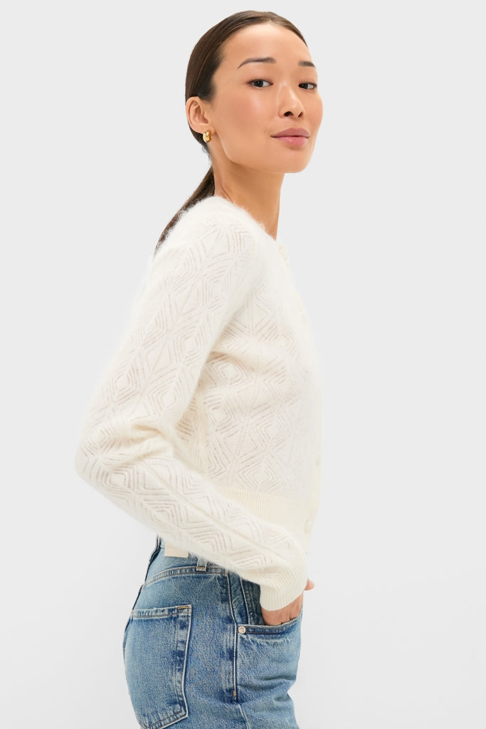 Young woman models the Ivory Brushed Merino Wool Macy Cardigan, showcasing its classic, textured knit and effortless style, paired with high-end denim for a fun, chic look.