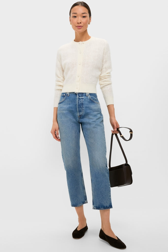 Model wearing an Ivory Brushed Merino Wool Macy Cardigan, paired with classic blue jeans and ballet flats, showcasing an effortless, high-end, and fun casual-chic style.