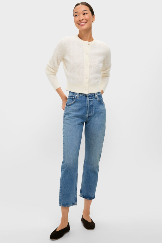 Model wearing the classic Ivory Brushed Merino Wool Macy Cardigan, effortlessly styled with mid-blue cropped jeans and dark slip-on flats, showcasing a fun, high-end, casual look.