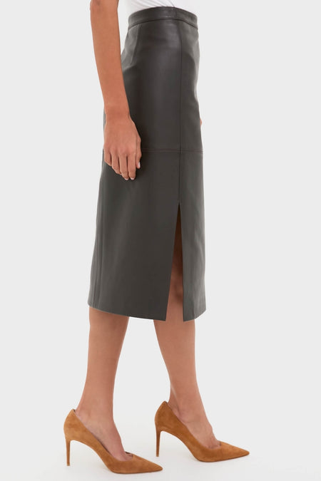 Model showcasing the Demitasse Leather Elene Midi Skirt, a classic and high-end pencil design with a back slit, paired effortlessly with tan suede high-heeled pumps.