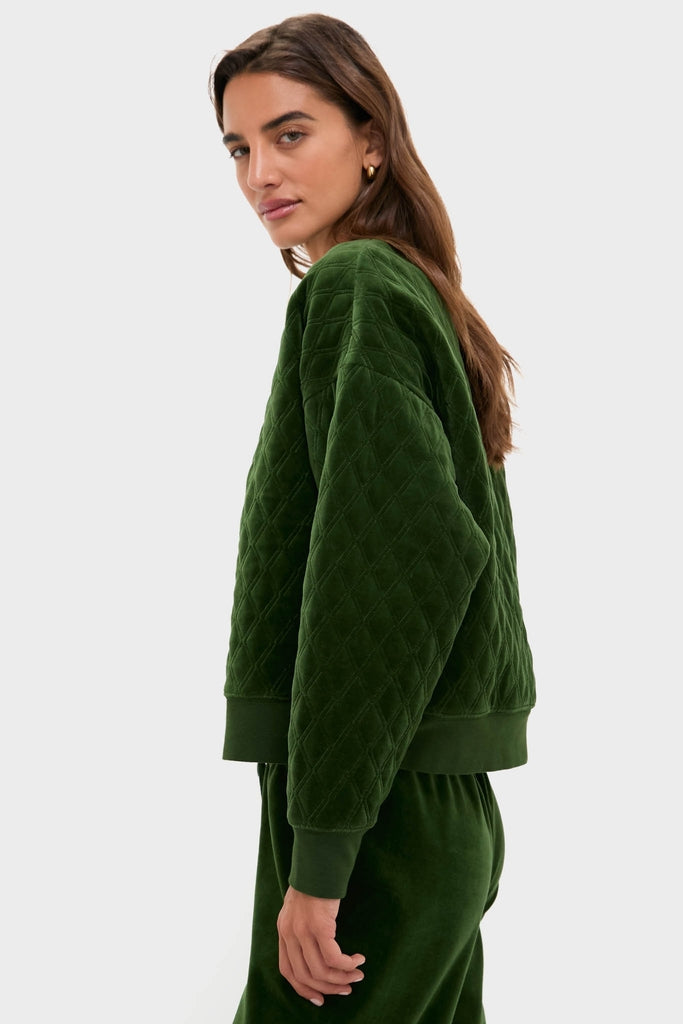 Woman in profile wearing the classic Douglas Fir Velour Bennett Pullover, exuding effortless, high-end style with its quilted design and relaxed fit, embodying Tuckernuck's fun, chic vibe.