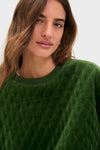 Woman wearing the classic Douglas Fir Velour Bennett Pullover, showcasing its quilted body and relaxed fit, creating an effortless, high-end loungewear look.