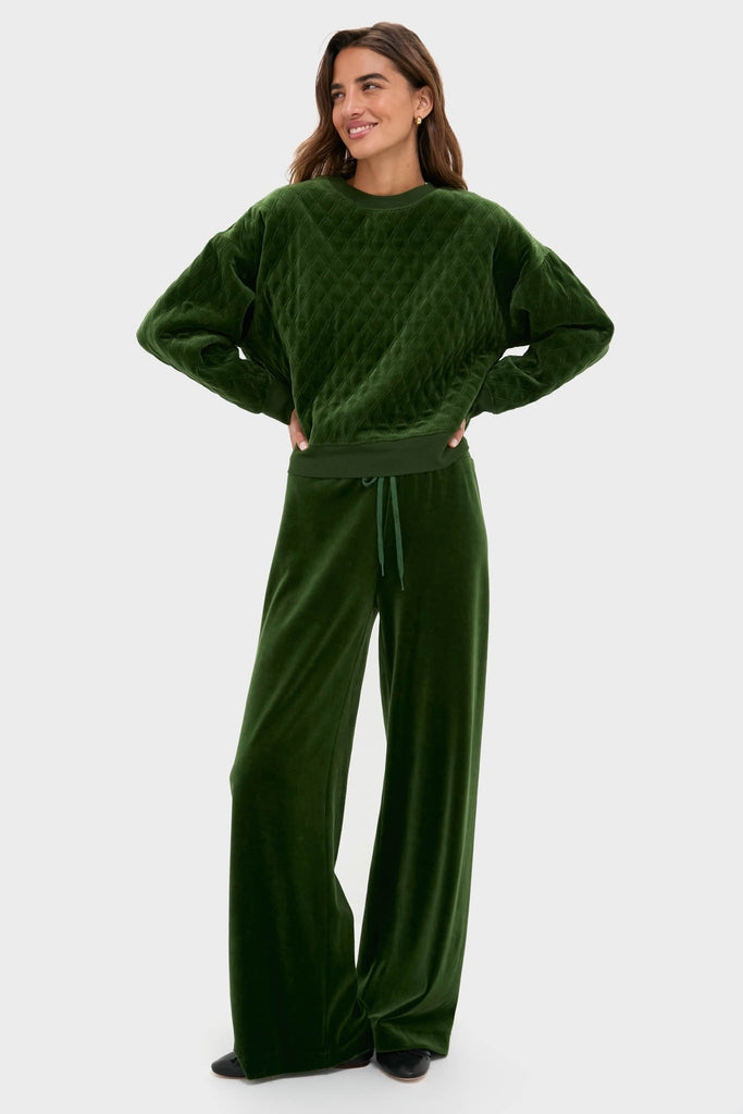 Woman models the classic Douglas Fir Velour Bennett Pullover and matching pants, offering an effortless, high-end loungewear look with quilted details and relaxed fit.