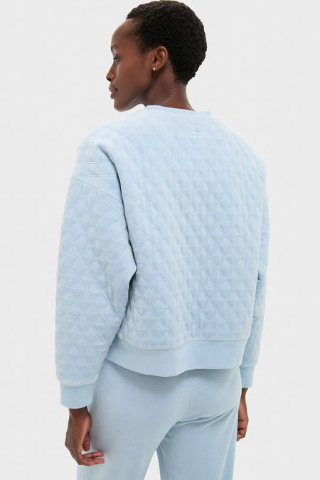 Woman in a relaxed fit Blue Fog Velour Bennett Pullover with quilted body and ribbed finishes, epitomizing classic, effortless, and high-end loungewear style.
