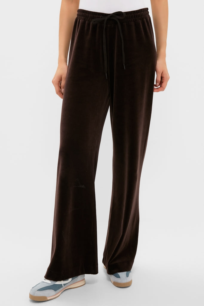 Model wearing classic Chocolate Brown Velour Jane Pant, showcasing its effortless wide-leg design and high-end elastic waistband with drawstring, paired with a white top and sneakers.