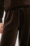 Close-up of a classic, high-end Chocolate Brown Velour Jane Pant, showcasing its effortless style with a quilted-pattern top and elastic waistband for fun, relaxed comfort.