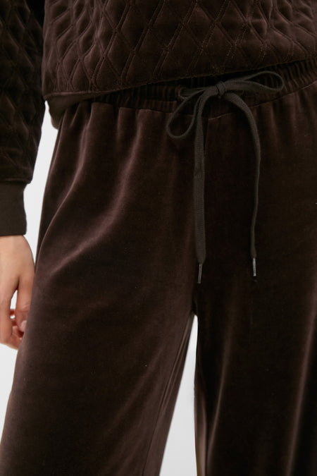 Close-up of a classic, high-end Chocolate Brown Velour Jane Pant, showcasing its effortless style with a quilted-pattern top and elastic waistband for fun, relaxed comfort.