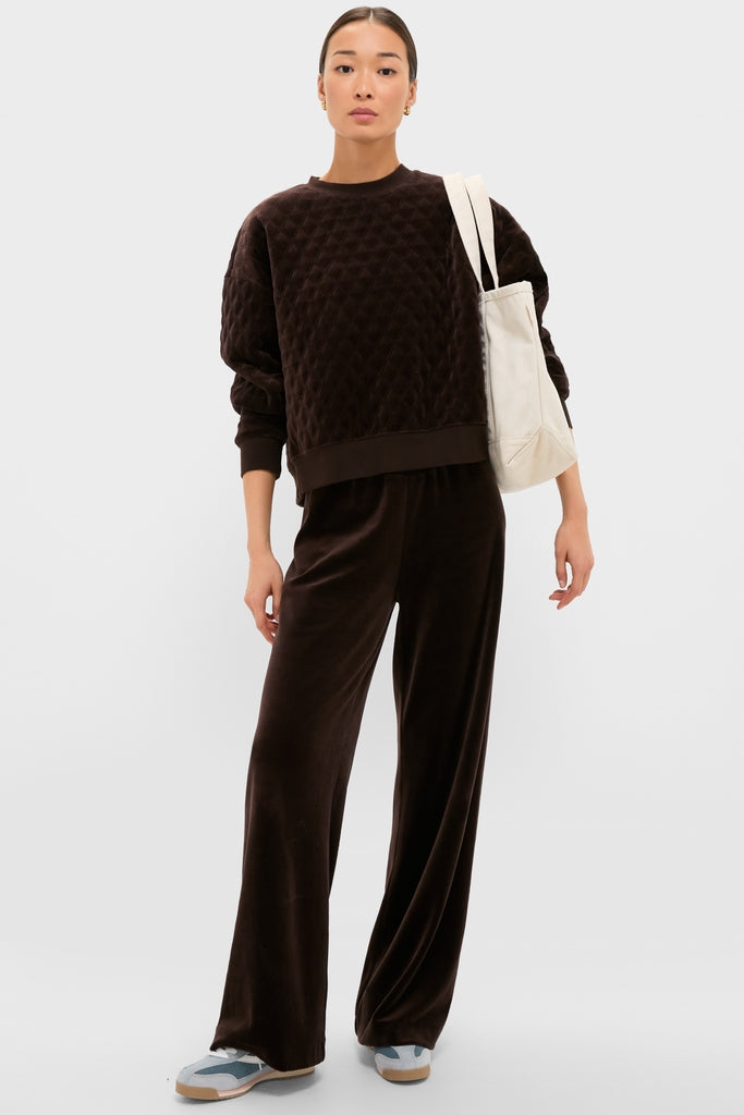 Model showcasing the classic Chocolate Brown Velour Jane Pant, featuring a high-rise, wide-leg silhouette, and elastic waistband for an effortless, high-end loungewear look.