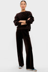Woman in classic Chocolate Brown Velour Jane Pant with wide-leg silhouette, paired with matching pullover, exudes effortless style and comfort, embodying Tuckernuck's fun, high-end loungewear.