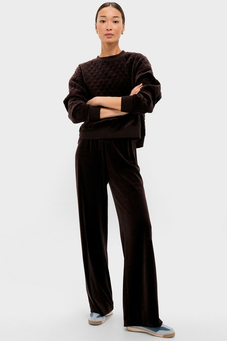 Woman in classic Chocolate Brown Velour Jane Pant with wide-leg silhouette, paired with matching pullover, exudes effortless style and comfort, embodying Tuckernuck's fun, high-end loungewear.