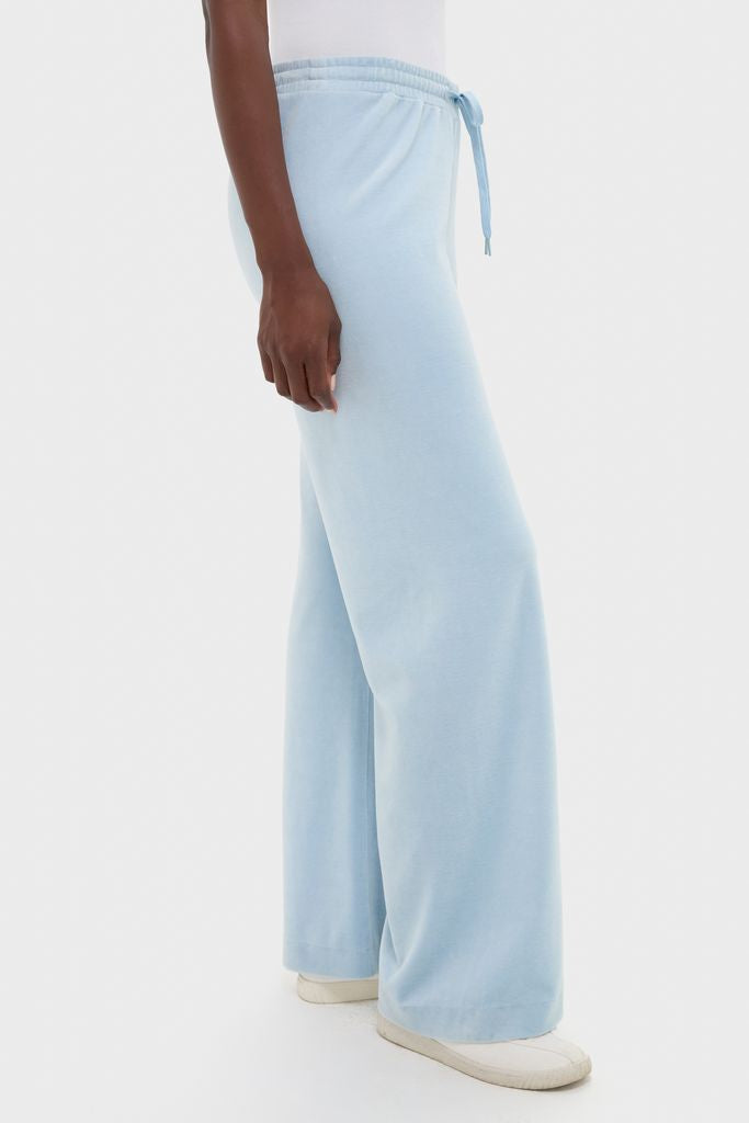 Blue Fog Velour Jane Pant features a classic wide-leg silhouette, elasticated drawstring waist, and effortless style, paired with white slip-on sneakers for a high-end, fun look.