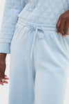Close-up of Blue Fog Velour Jane Pant featuring a classic quilted sweatshirt, showcasing its effortless, high-end style with an elastic waistband and relaxed fit for ultimate comfort.