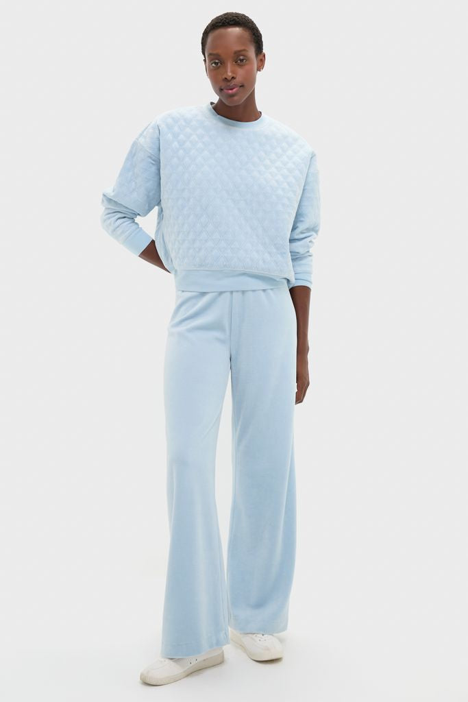 Person wearing Blue Fog Velour Jane Pant, a classic, high-end loungewear set with relaxed fit and wide-leg silhouette, styled effortlessly for fun and comfort.