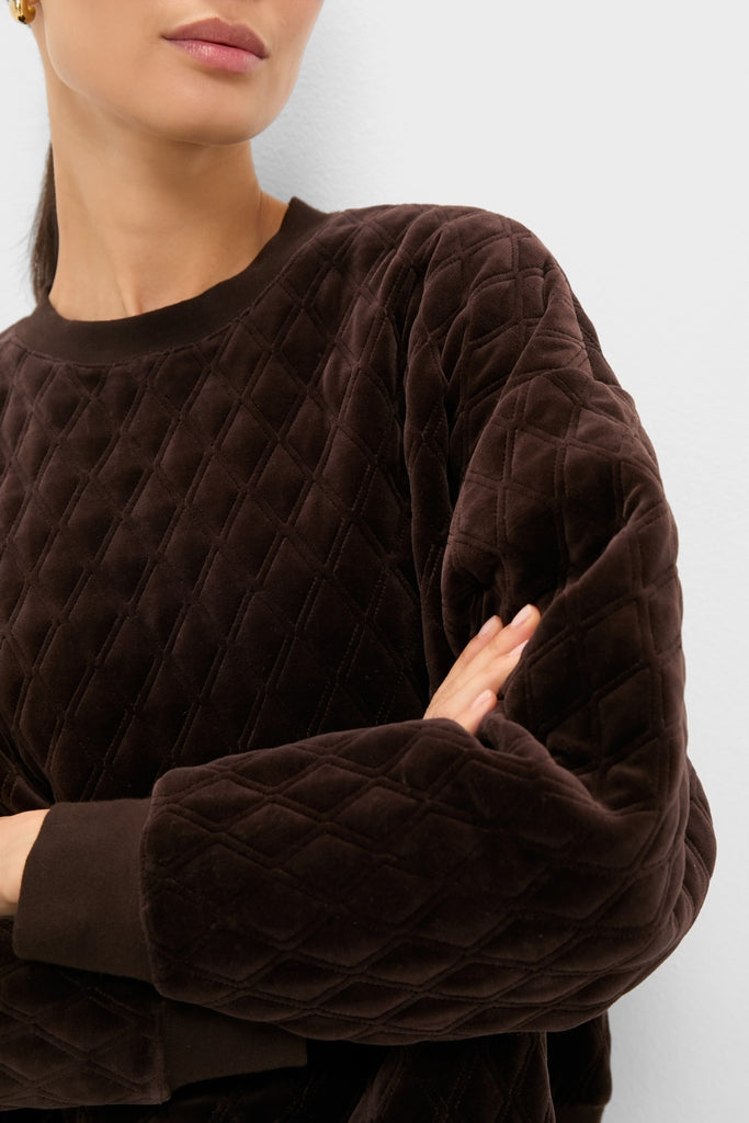 Person wearing the classic, high-end Chocolate Brown Velour Bennett Pullover with quilted diamond-stitch and ribbed cuffs, embodying an effortless, fun, and relaxed weekend style.
