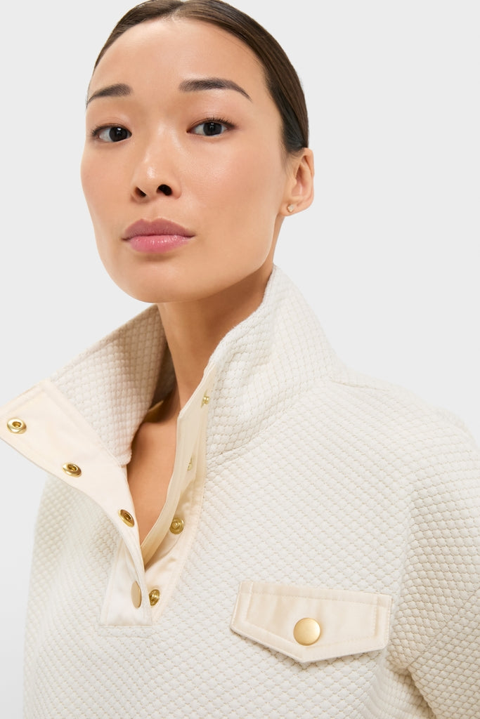 Cream Snap Neck Brooke Pullover featuring a classic quilt-style knit pattern, high collar, and gold snap buttons, offering an effortless and high-end look.