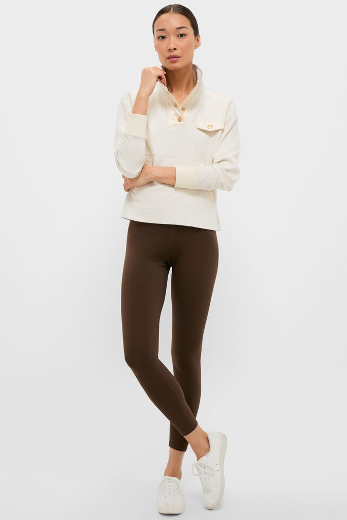 Young woman in a classic, cream Snap Neck Brooke Pullover with a quilted design, embodying an effortless, high-end style with fun, casual flair.