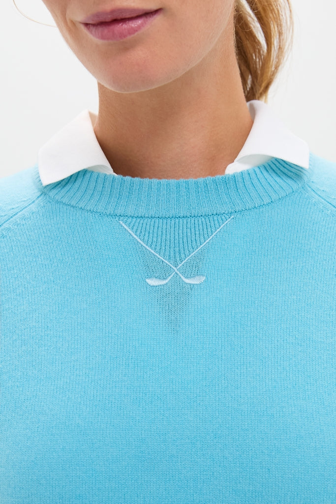 Bright Blue Washable Cashmere Malcolm Crewneck featuring classic raglan sleeves, effortless embroidered golf club motif, and fun rib-knit trim, embodying Tuckernuck’s high-end style.