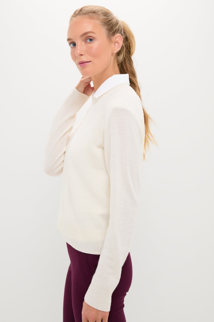 Young woman in profile wearing the classic Buttercream Washable Cashmere Malcolm Crewneck with raglan sleeves, exuding effortless, high-end style, perfect for fun, versatile outings.