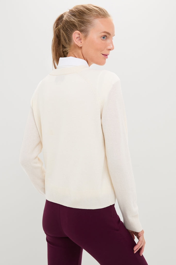 Woman wearing the Buttercream Washable Cashmere Malcolm Crewneck, featuring a classic, effortless look with raglan sleeves and rib-knit trim, paired with stylish burgundy pants.