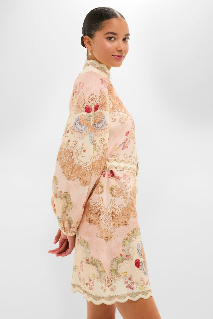 Woman in a classic, high-end Wallpaper Floral Blush Daylight Mini Dress with scalloped collar, billowy sleeves, and ornate print, exuding effortless elegance and fun sophistication.